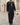 Remah Kandura – Men's Black Tassel Emirati Thobe, walking toward camera – Thobe Wala